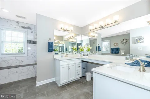 a kitchen with white cabinets and appliances