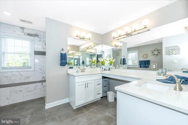 a kitchen with white cabinets and appliances