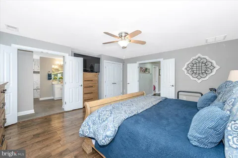 a kitchen with stainless steel appliances kitchen island granite countertop a stove a sink dishwasher a refrigerator a oven with a dining table and chairs