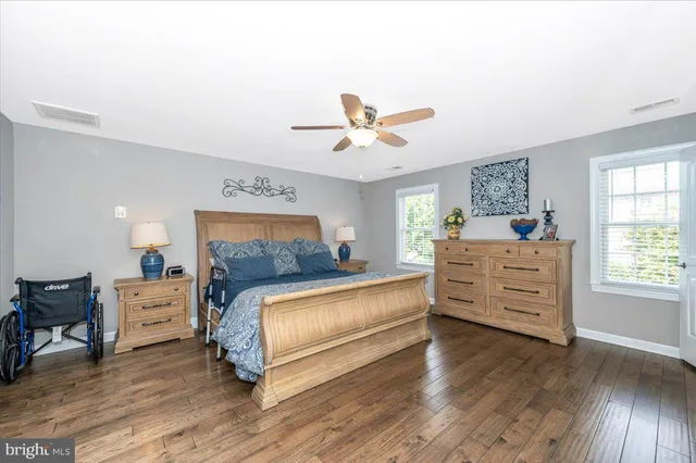 a kitchen with a table chairs refrigerator and cabinets