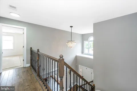 a living room with fireplace furniture and a wooden floor