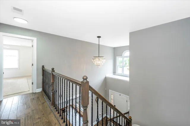 a living room with fireplace furniture and a wooden floor