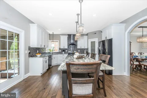 a view of a house with backyard porch and sitting area