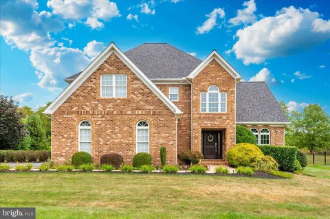 a living room with patio furniture and a floor to ceiling window