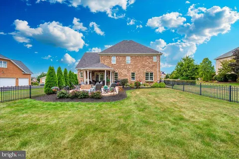 a front view of a house with a yard table and chairs