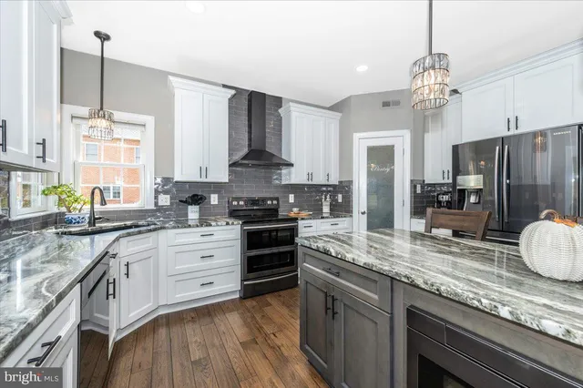 a living room with furniture a clock on wall and a window
