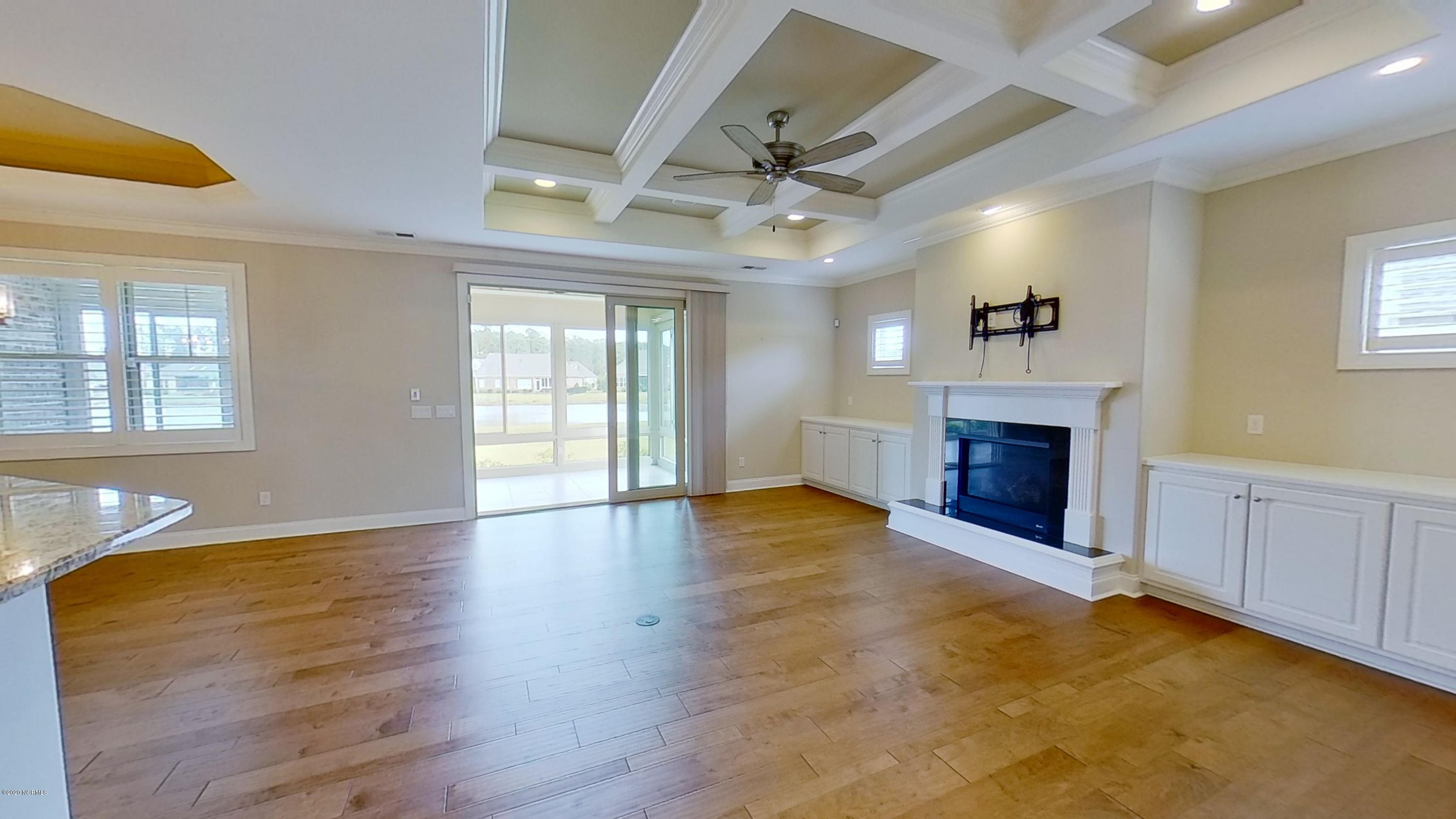2140 Springstone Drive Leland, NC 28451 - Photo 12 of 38 Living room features gas fireplace flanked with built-in cabinets and coffered ceiling