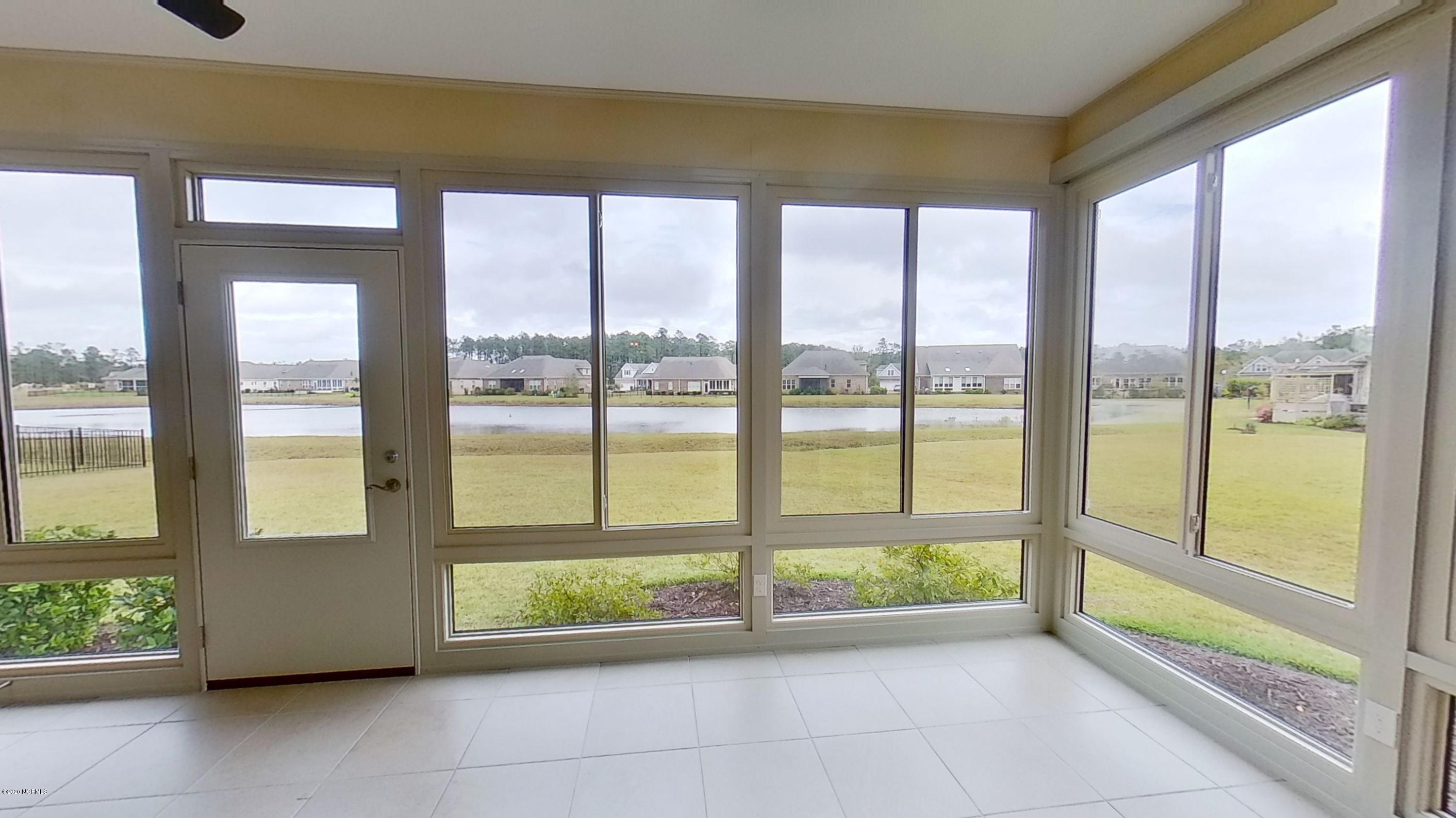 2140 Springstone Drive Leland, NC 28451 - Photo 20 of 38 Sunroom overlooking backyard and pond