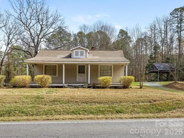 a front view of a house with a garden and porch