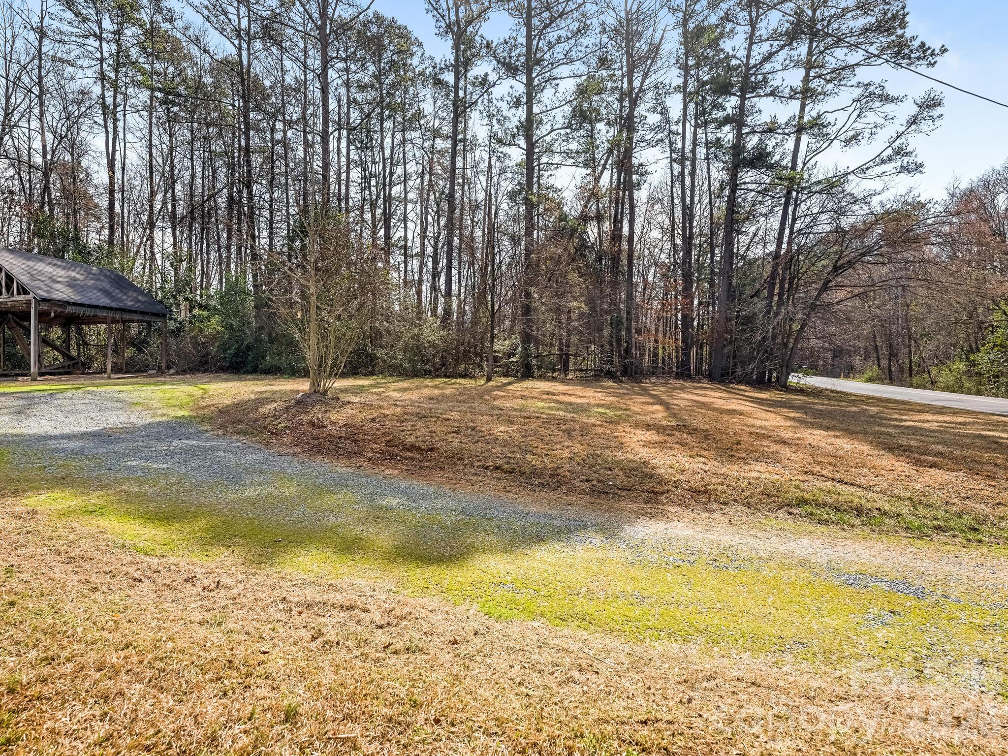 2346 Sam Newell Road Matthews, NC 28105 - Photo 15 of 18 a swimming pool with trees in front of it