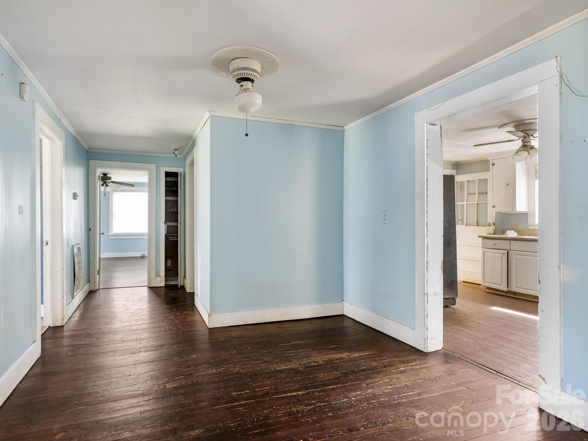 2346 Sam Newell Road Matthews, NC 28105 - Photo 6 of 18 a view of a hallway with wooden floor and a kitchen