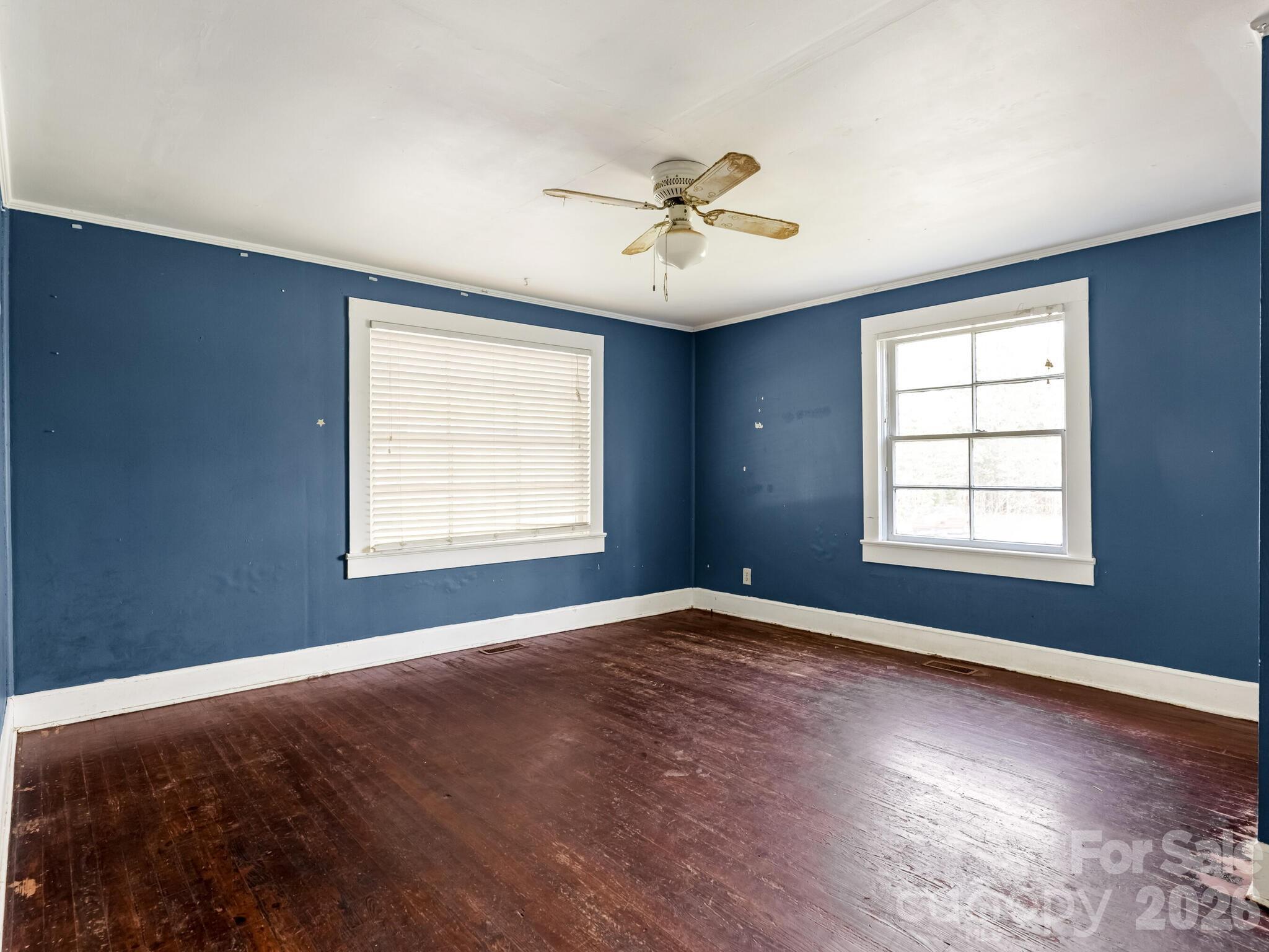 2346 Sam Newell Road Matthews, NC 28105 - Photo 10 of 18 a view of a big room with windows and chandelier fan
