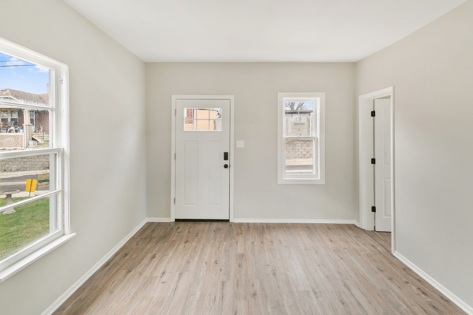 8 Ivy Street Joliet, IL 60436 - Photo 2 of 13 an empty room with wooden floor and windows