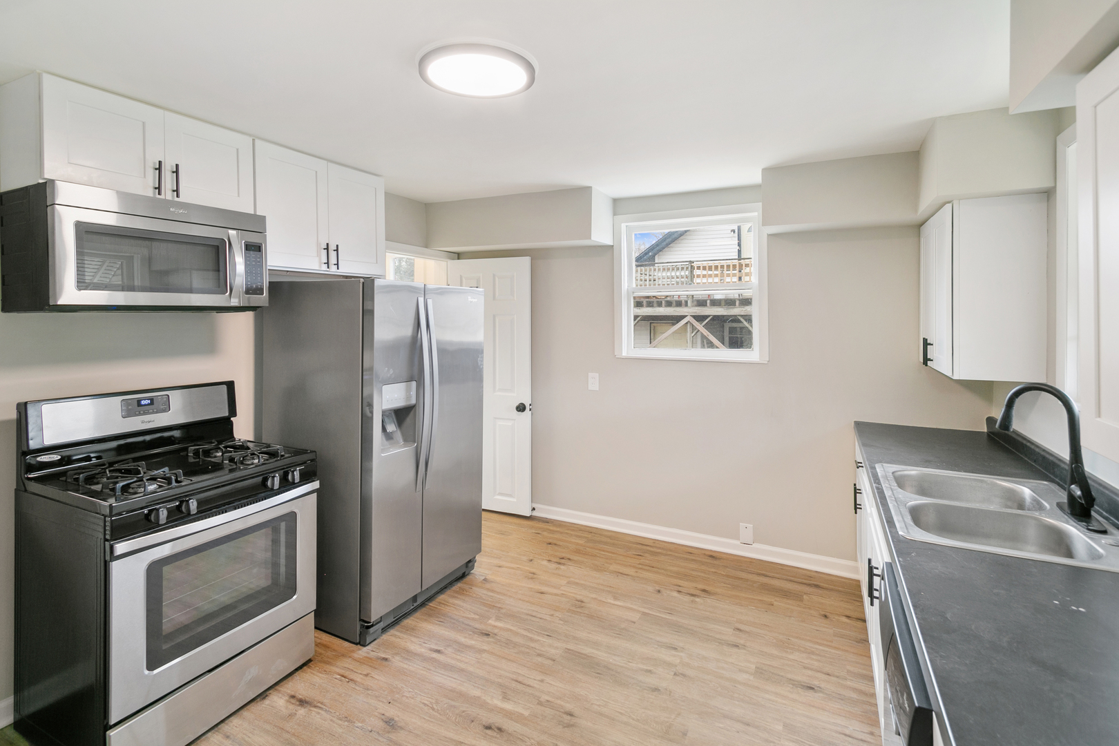 8 Ivy Street Joliet, IL 60436 - Photo 7 of 13 a kitchen with granite countertop a refrigerator stove and sink