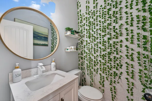 a bathroom with double vanity sinks a vanity a lamp and a mirror