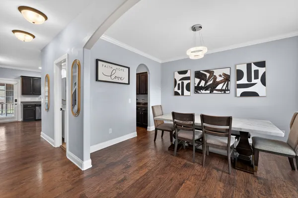 a view of a dining room with furniture wooden floor and a rug