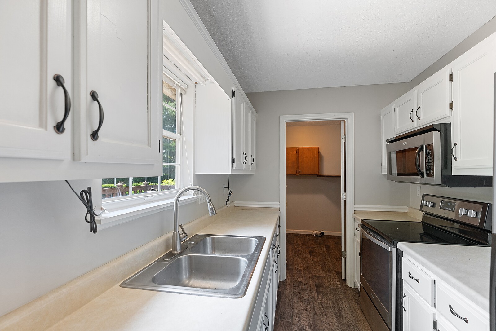 238 Hester Road Portland, TN 37148 - Photo 8 of 17 a kitchen with a refrigerator sink and white cabinets