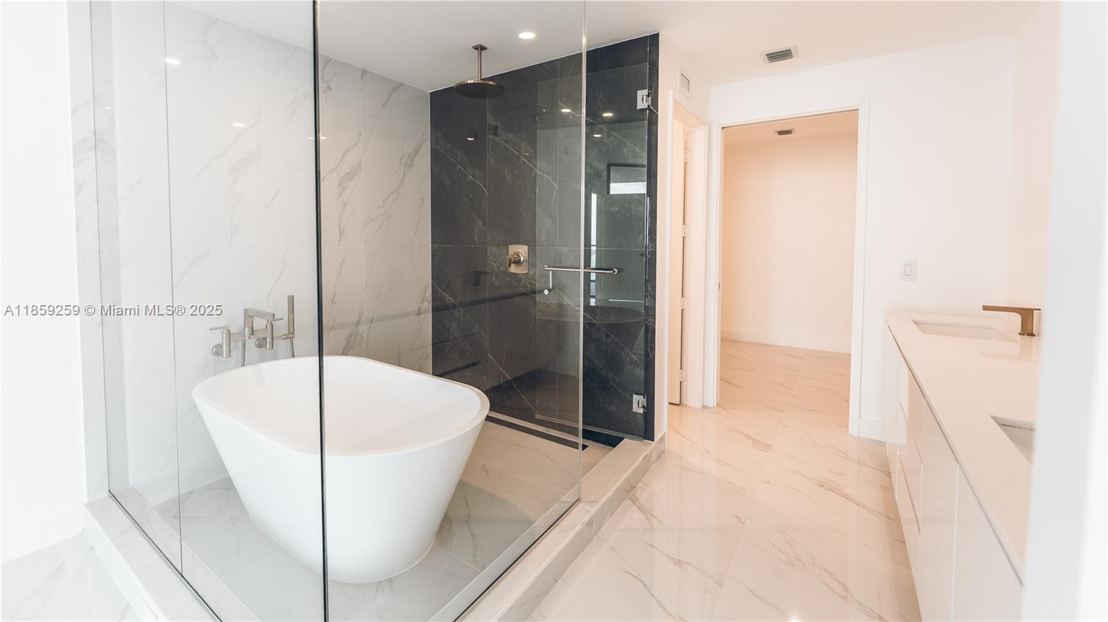 700 Northeast 24th Street, Unit 4407 Miami, FL 33137 - Photo 62 of 75 a bathroom with a tub and a shower