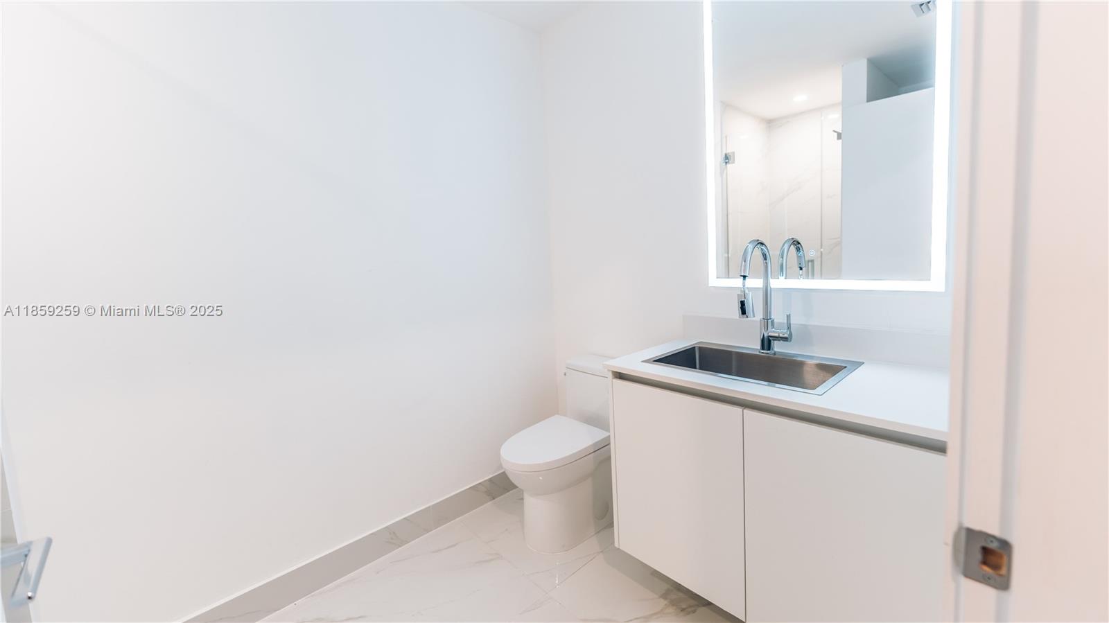 700 Northeast 24th Street, Unit 4407 Miami, FL 33137 - Photo 71 of 75 a bathroom with a sink a toilet and a mirror