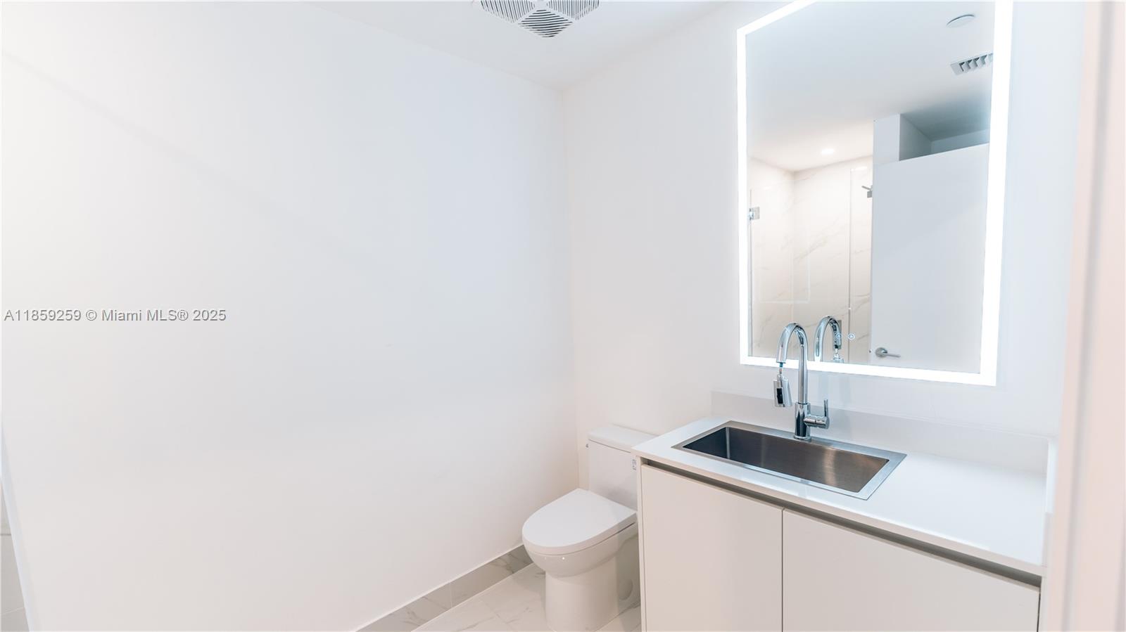 700 Northeast 24th Street, Unit 4407 Miami, FL 33137 - Photo 72 of 75 a bathroom with a sink a toilet and mirror