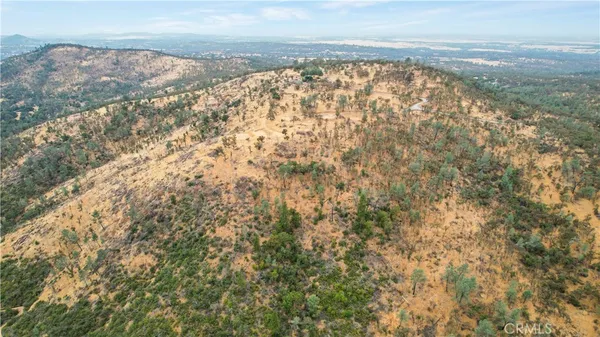 a view of a dry yard with mountains