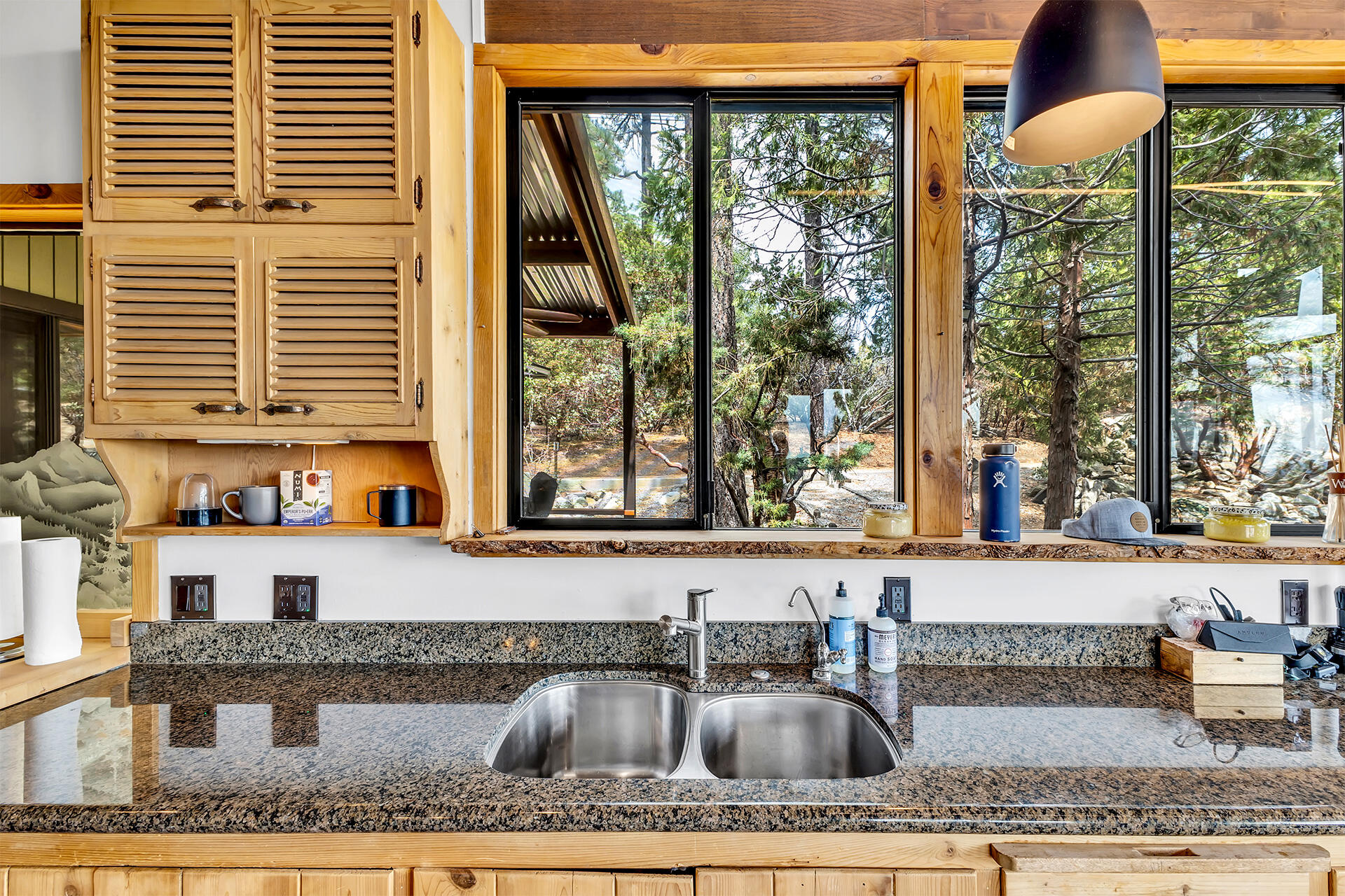 27011 Lookout Lane Idyllwild, CA 92549 - Photo 31 of 68 a kitchen with a granite countertop sink and wooden cabinets