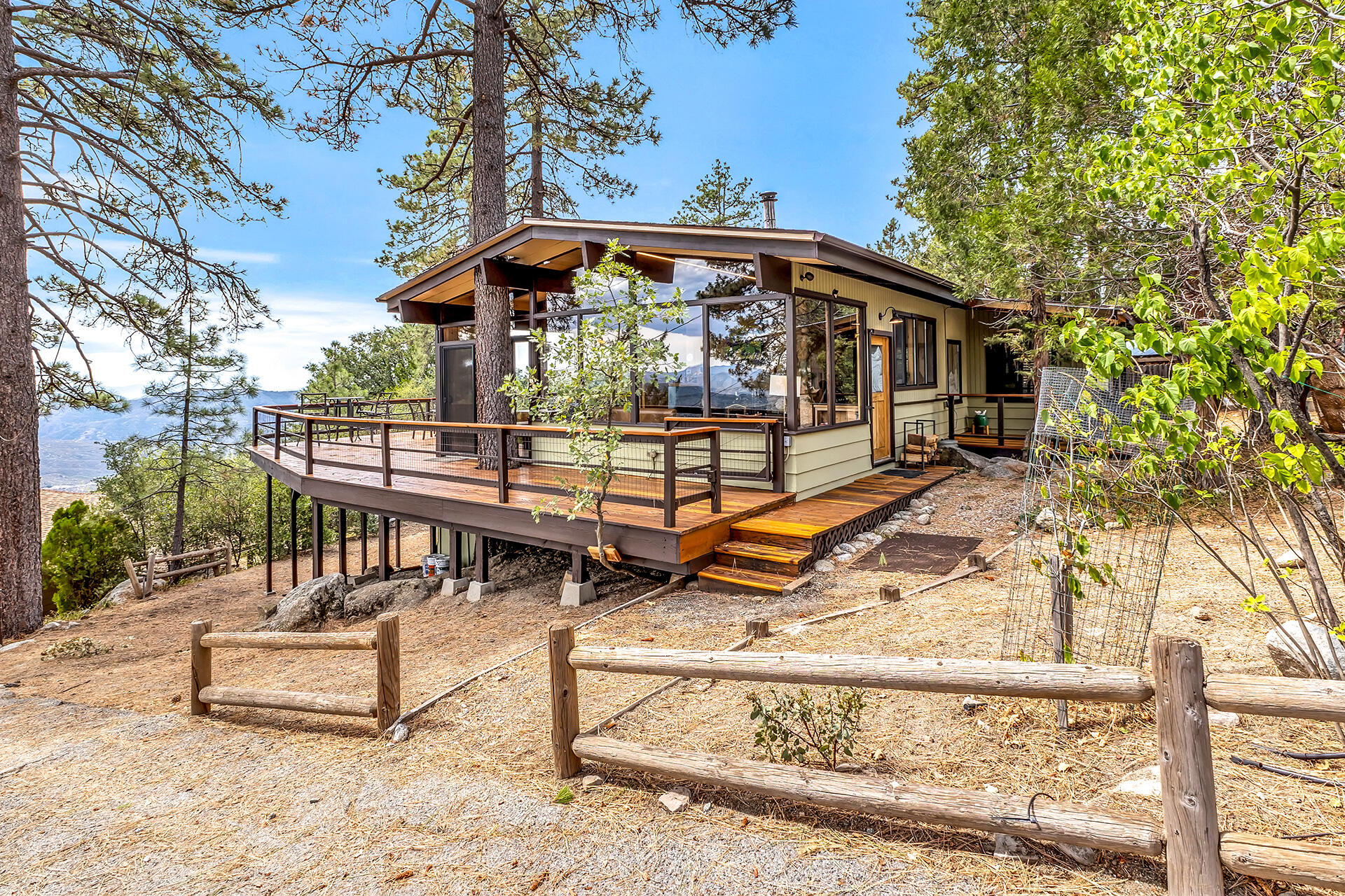 27011 Lookout Lane Idyllwild, CA 92549 - Photo 10 of 68 a view of a roof deck with wooden fence and a bench