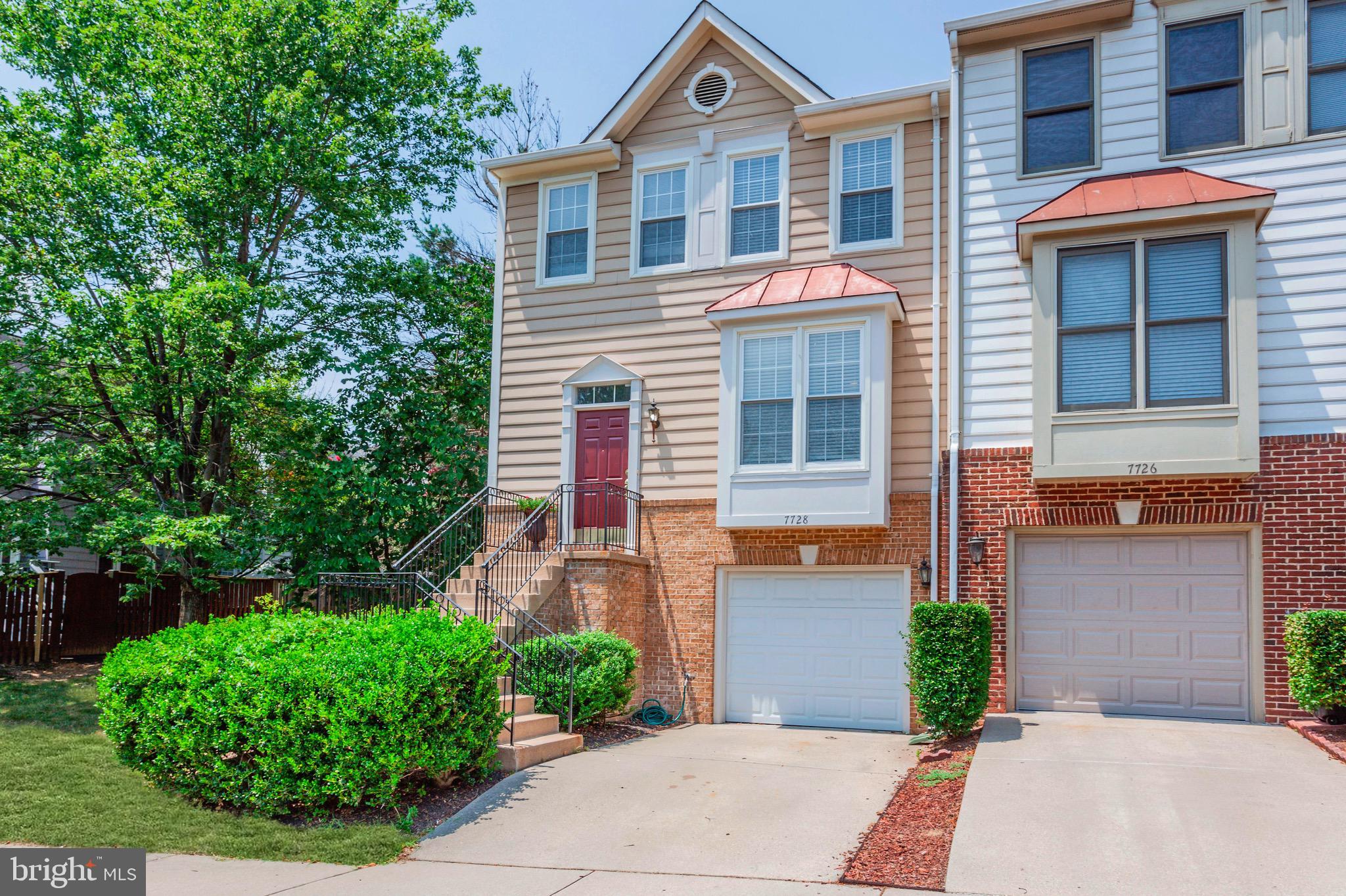 7728 Hickory Glen Way Springfield, VA 22153 - Photo 2 of 26 a front view of a house with garden