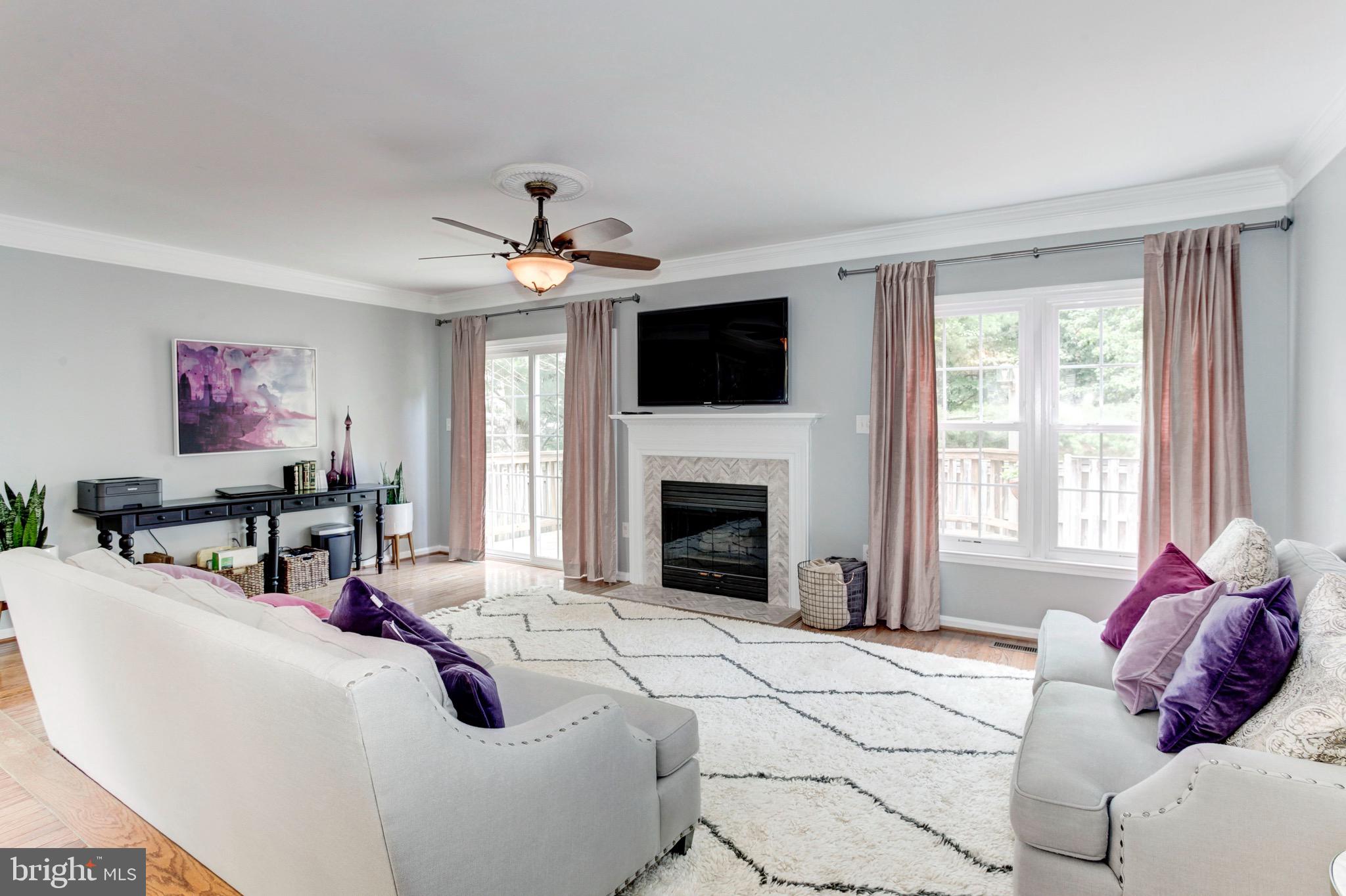 7728 Hickory Glen Way Springfield, VA 22153 - Photo 11 of 26 a living room with fireplace furniture and a flat screen tv