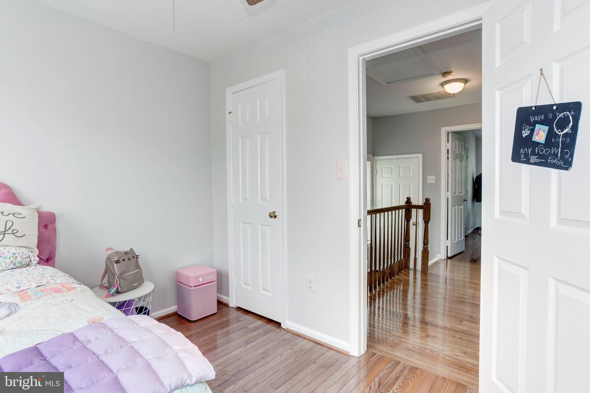 7728 Hickory Glen Way Springfield, VA 22153 - Photo 19 of 26 a spacious bedroom with a bed and a wooden floor