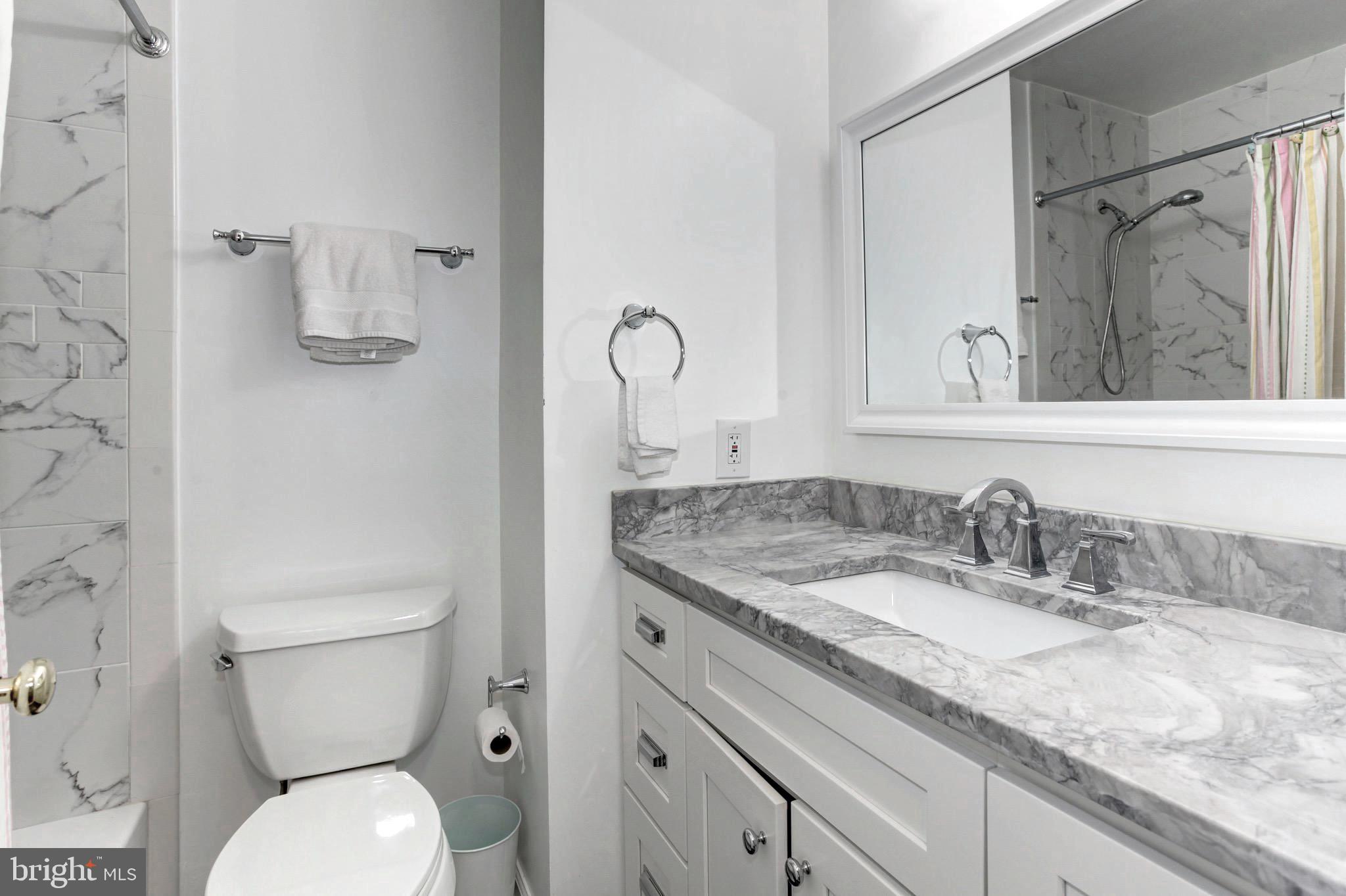 7728 Hickory Glen Way Springfield, VA 22153 - Photo 20 of 26 a bathroom with a granite countertop toilet sink and mirror