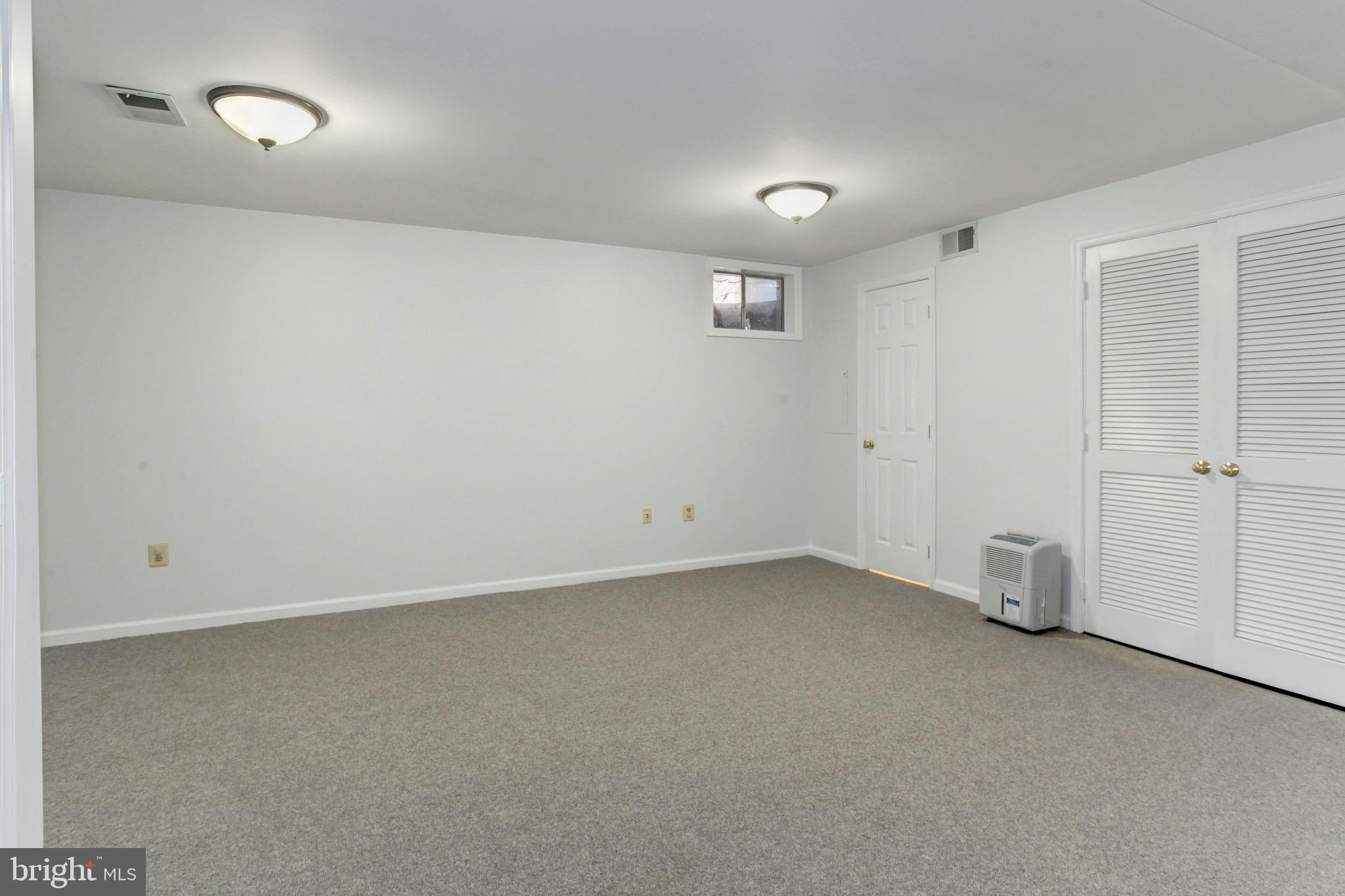 7728 Hickory Glen Way Springfield, VA 22153 - Photo 21 of 26 an empty room with a empty space and windows