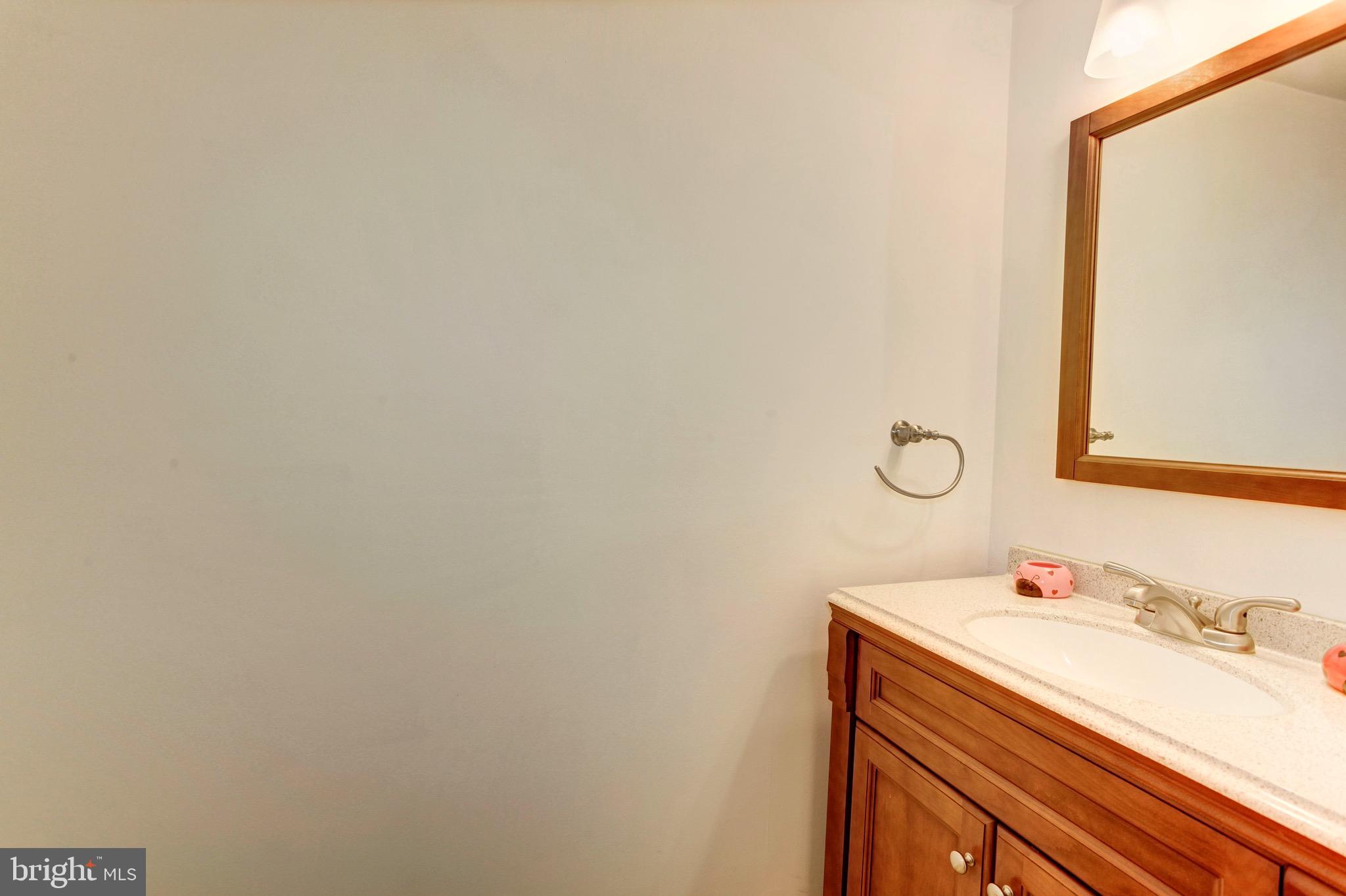 7728 Hickory Glen Way Springfield, VA 22153 - Photo 23 of 26 a bathroom with a sink and a mirror