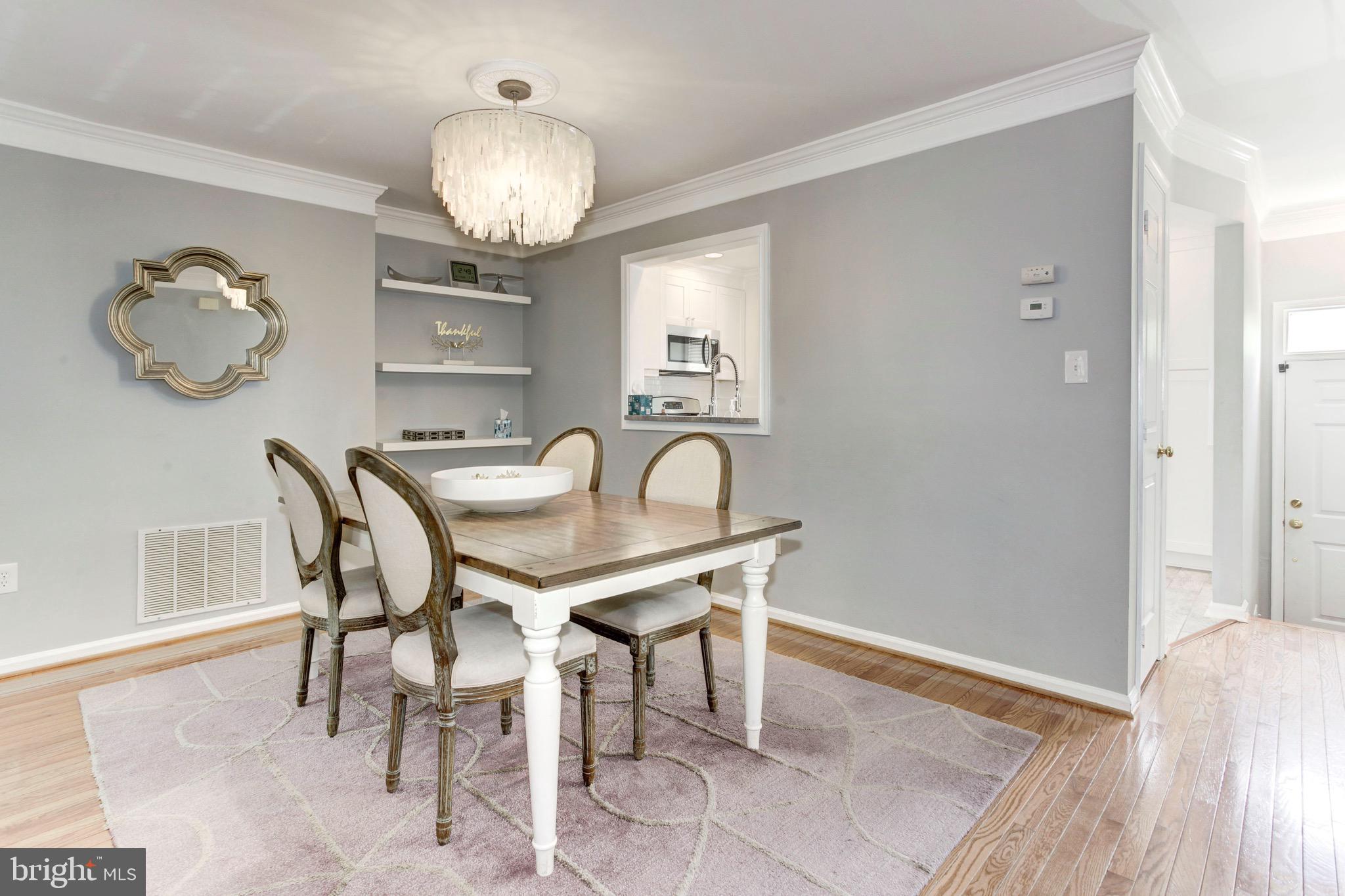 7728 Hickory Glen Way Springfield, VA 22153 - Photo 8 of 26 a view of a dining room with furniture and chandelier