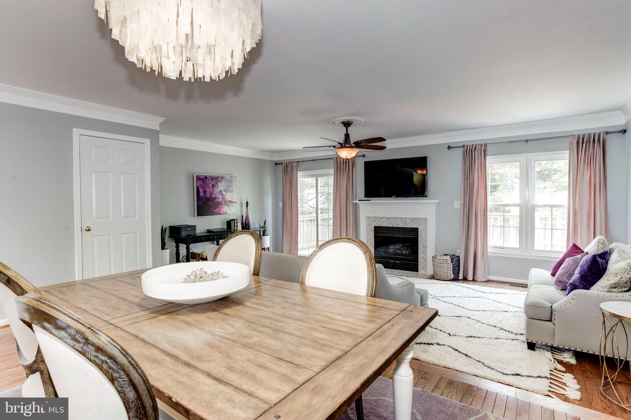 7728 Hickory Glen Way Springfield, VA 22153 - Photo 9 of 26 a living room with furniture a fireplace and a large window