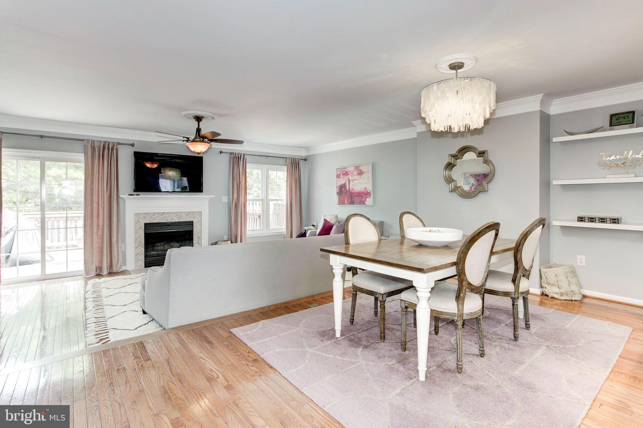 7728 Hickory Glen Way Springfield, VA 22153 - Photo 10 of 26 a living room with furniture a fireplace and dining table