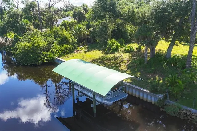 a view of a swimming pool with a patio and a yard