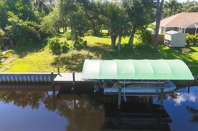 a wooden bench sitting in a backyard next to a lake