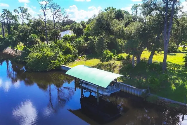 an aerial view of a swimming pool patio and lake view