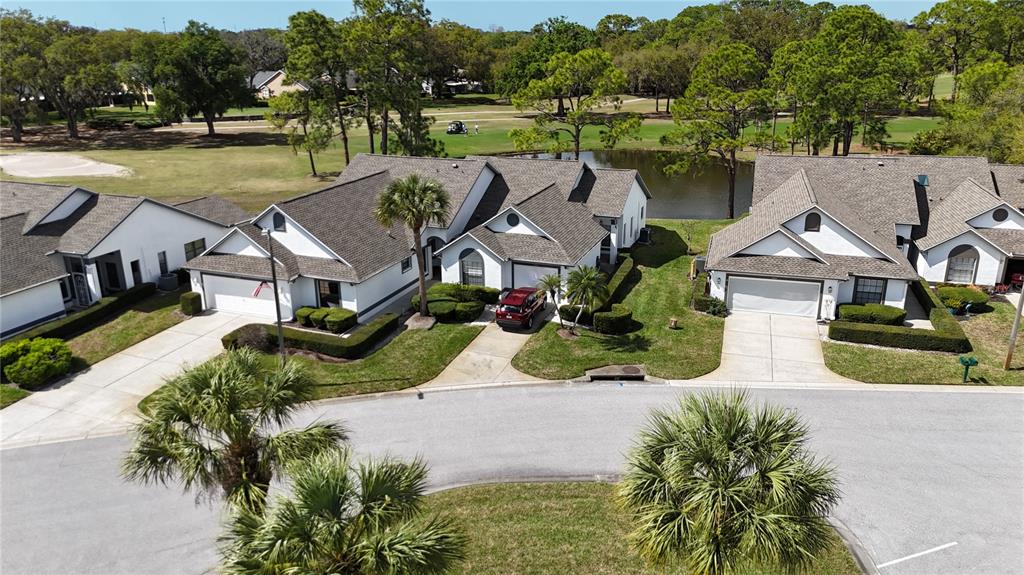 3637 Downfield Place, Unit 402 New Port Richey, FL 34655 - Photo 23 of 39 an aerial view of a house with garden space and street view