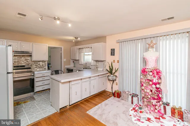 a kitchen with a sink stove and refrigerator
