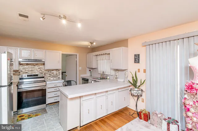 a kitchen with a sink stove and cabinets