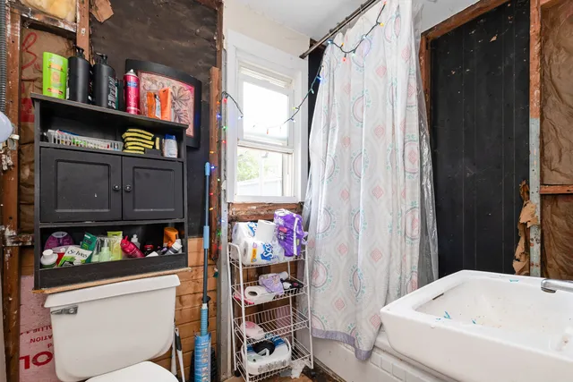 a bathroom with a tub and sink