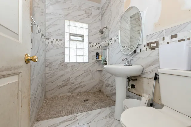 a bathroom with a sink toilet and shower