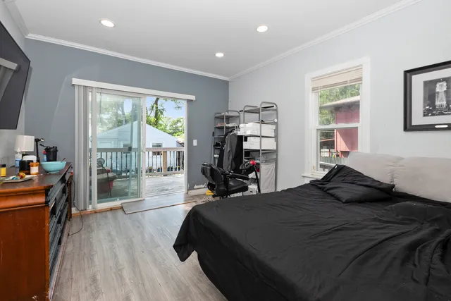 a bedroom with a bed and a large window