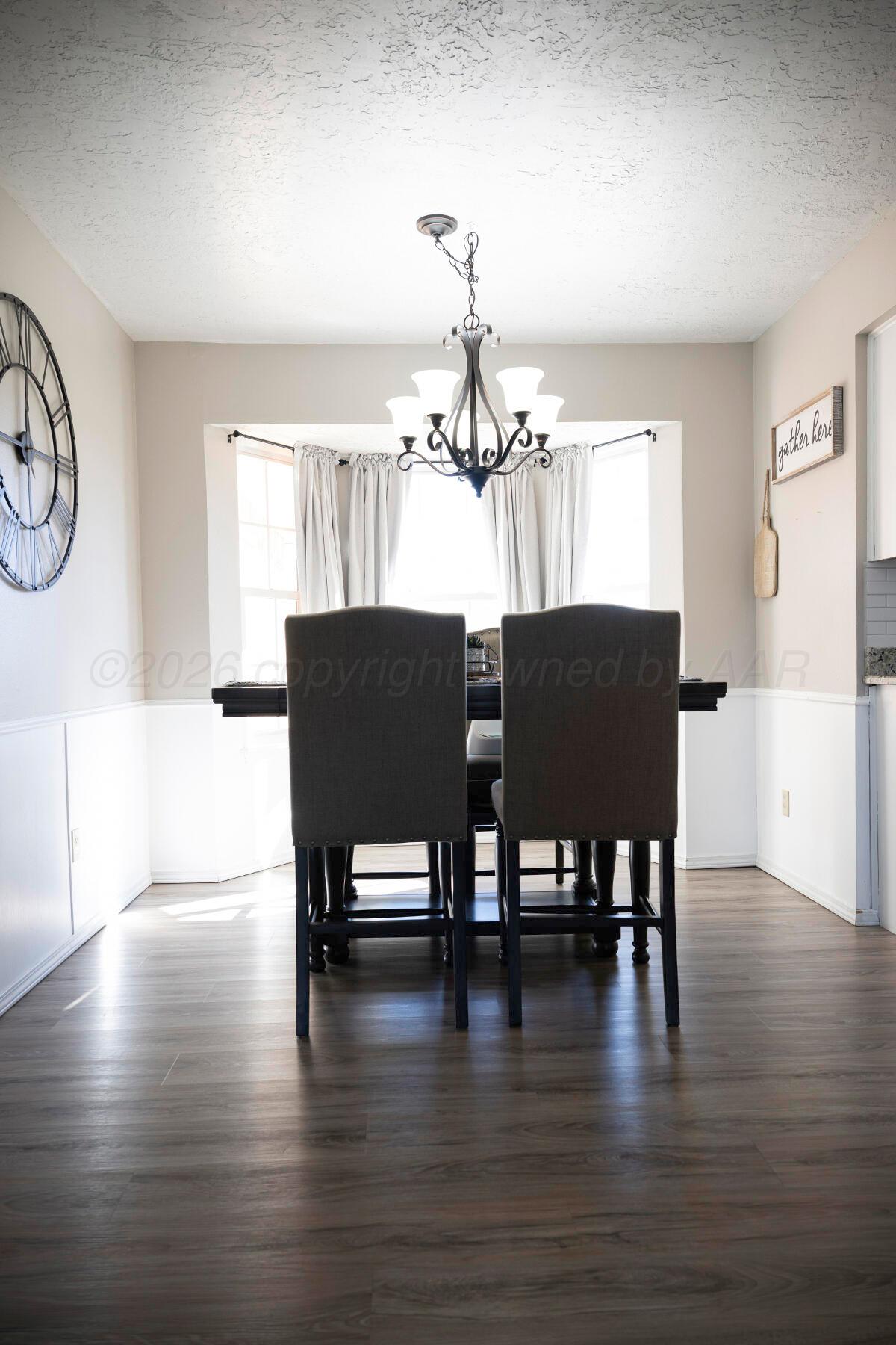 611 Floyd Avenue Dumas, TX 79029 - Photo 13 of 28 a view of a dining room with furniture window and wooden floor