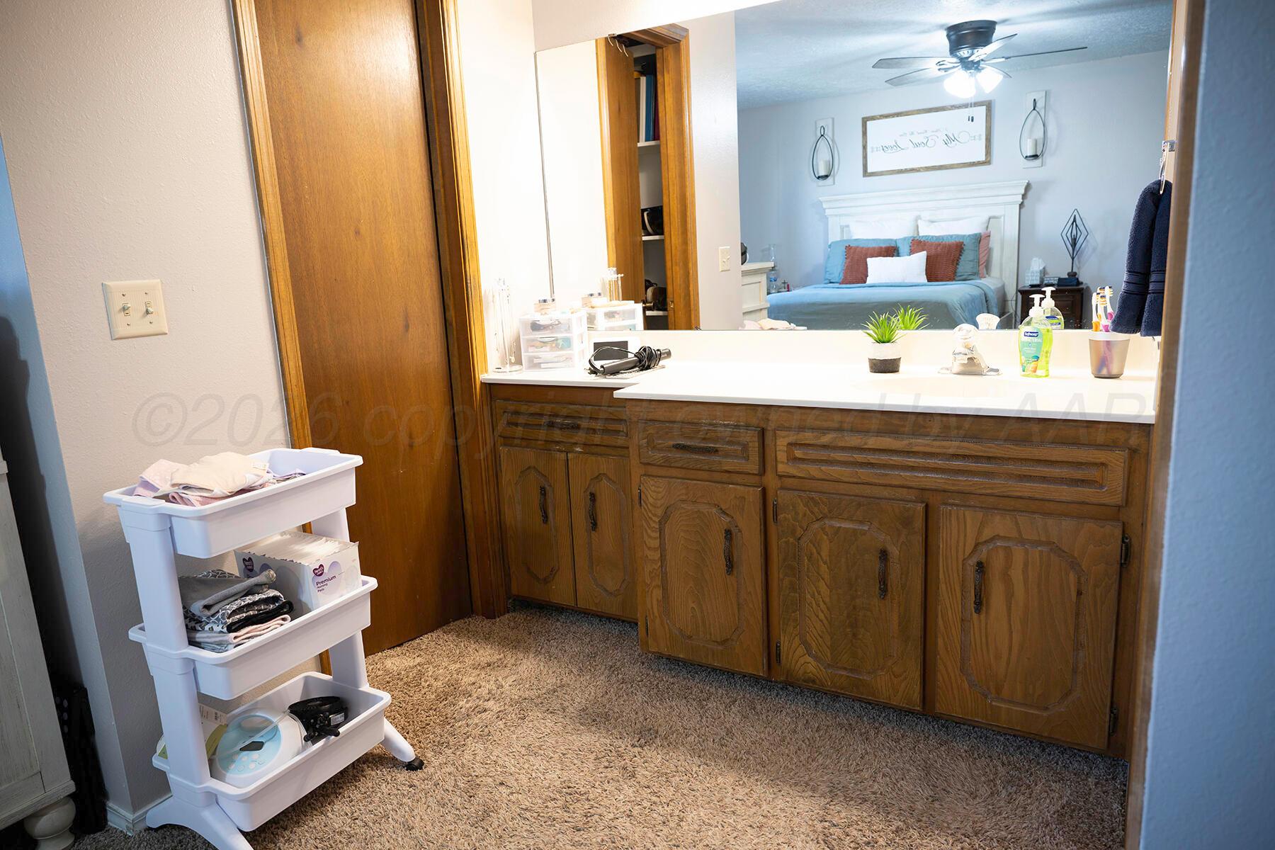 611 Floyd Avenue Dumas, TX 79029 - Photo 23 of 28 a bathroom with a sink mirror and vanity