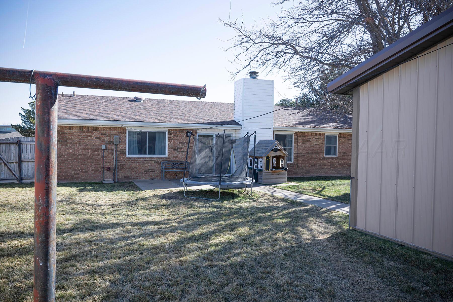 611 Floyd Avenue Dumas, TX 79029 - Photo 27 of 28 a view of a house with backyard and tree