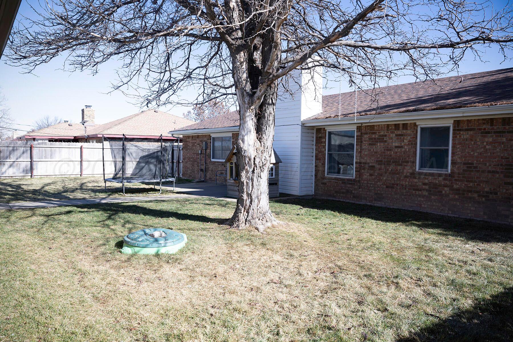 611 Floyd Avenue Dumas, TX 79029 - Photo 28 of 28 a view of a house with swimming pool and sitting area