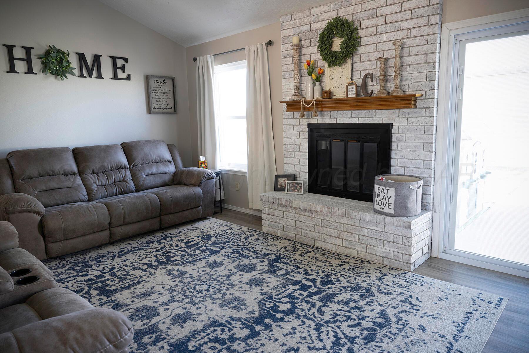 611 Floyd Avenue Dumas, TX 79029 - Photo 6 of 28 a living room with furniture and a fireplace